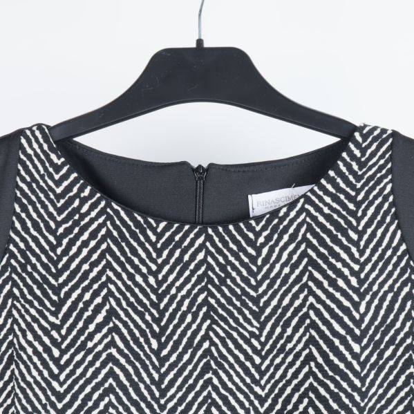 Närbild av klänningens halsringning och dragkedja