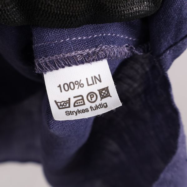 Materialetikett med 100% linne och tvättråd