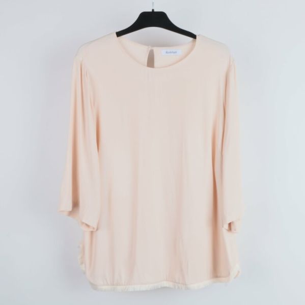 Framifrån av beige blus med rund halslinning