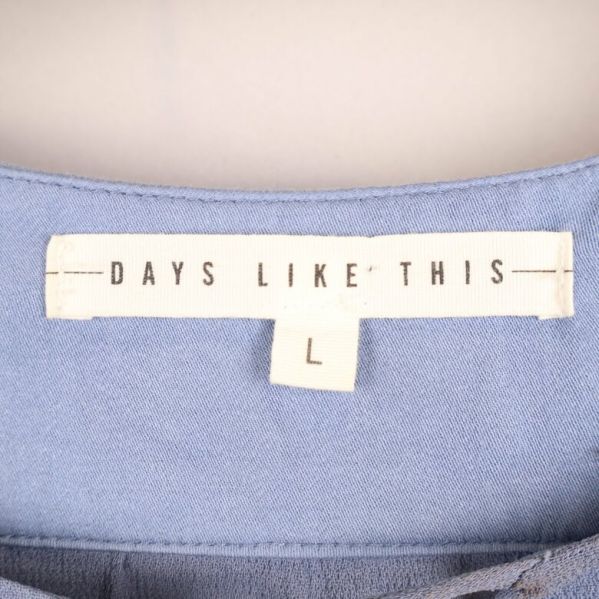 Etikett på blus med storlek L