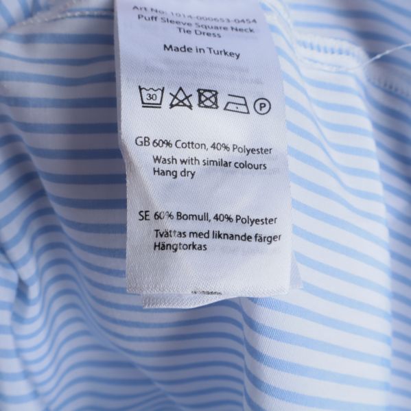 Materialetikett visar bomull och polyester