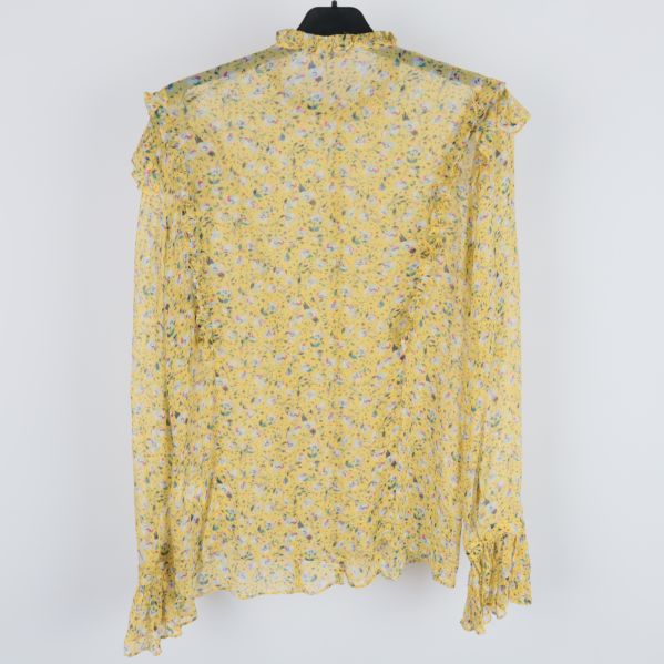 Baksida av gul blommig skjorta med volanger