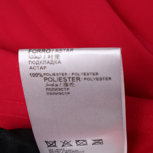 Materialetikett som visar 100% polyester