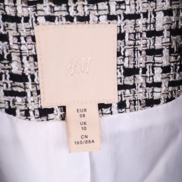 Etikett med H&M och storlek EU 38