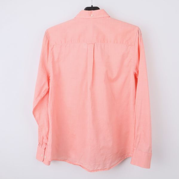 Baksida av persikafärgad skjorta med slät design
