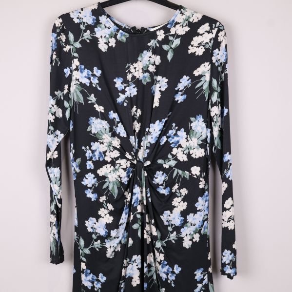 Närbild på knutdetalj och blommigt mönster