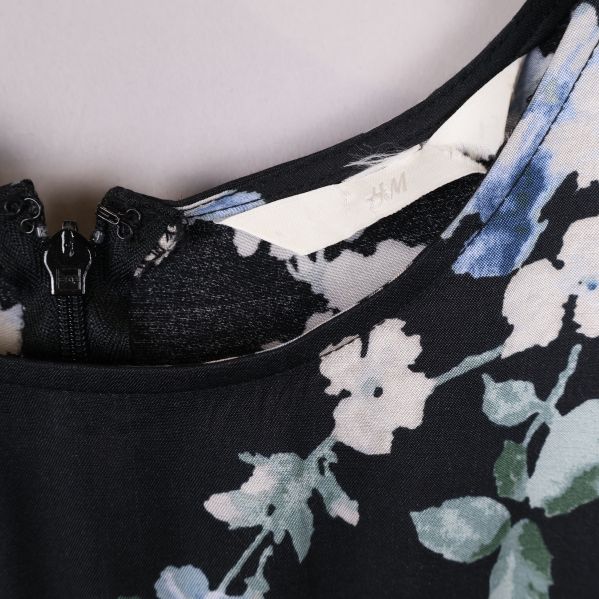 Märkesetikett i klänning med H&M-logo