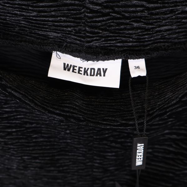 Närbild av Weekday-logotyp och storlekslapp på tights