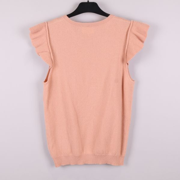 Stickad väst i aprikos färg bakifrån 