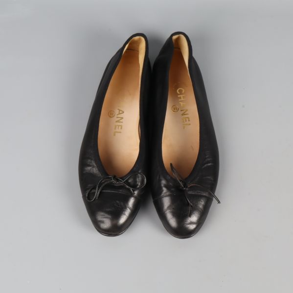 Ett par svarta ballerina med rosett ovanifrån