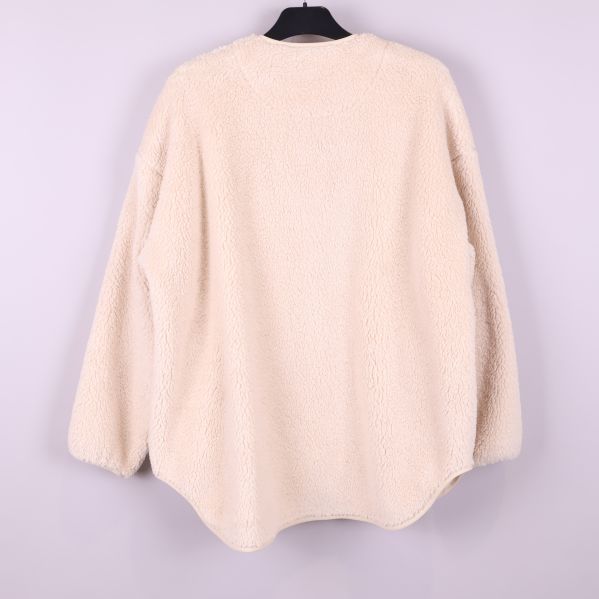 Baksida av beige fleecejacka med rak fåll