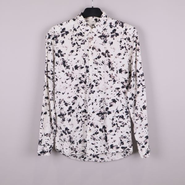 Svartvit mönstrad skjorta upphängd framifrån