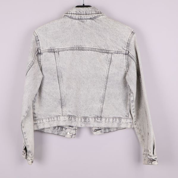 Baksida av ljus acid wash jeansjacka 
