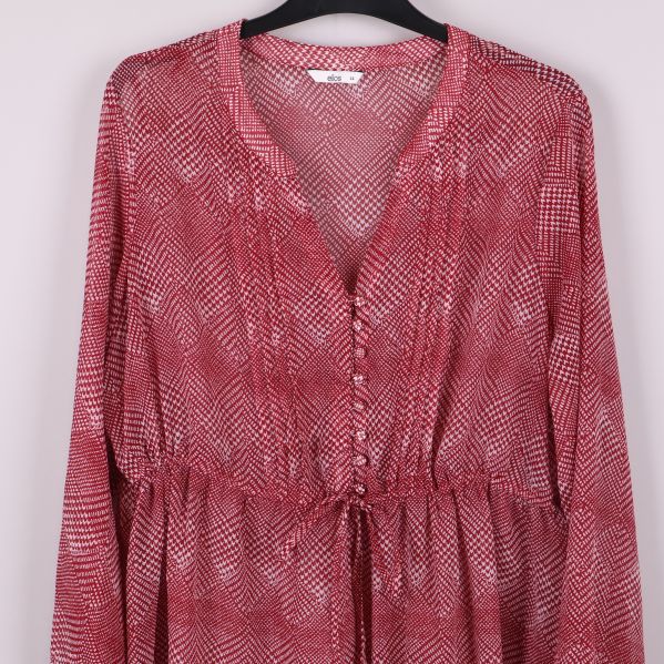 Närbild på bröstpartiet med knappar och v-ringning