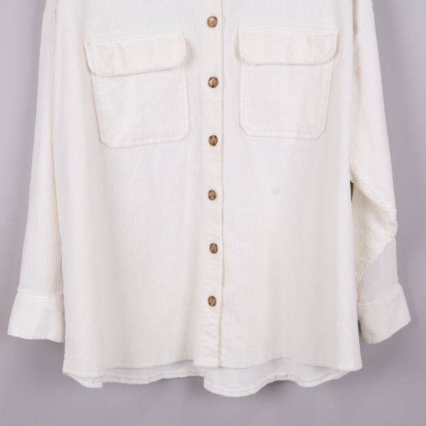 Nedre delen av vit skjorta och knappar fram