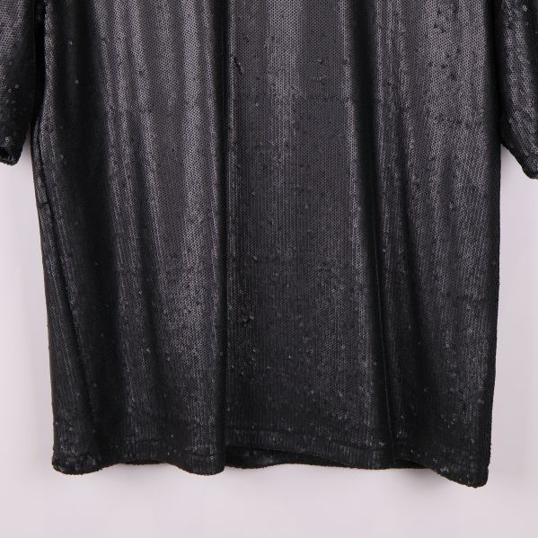 Nederdel av svart paljett tröja med raka sömmar