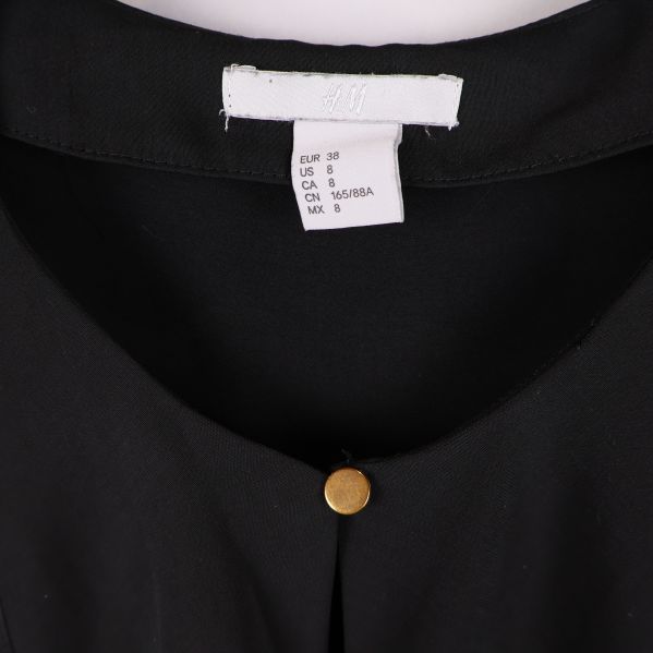 Storleksetikett för H&M blus i närbild