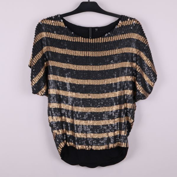 Framsida av topp med svarta och bronsfärgade paljettränder