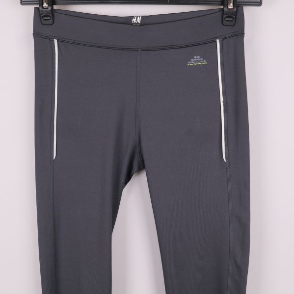 Tightsens midja med vita dragkedjor och reflexdetaljer