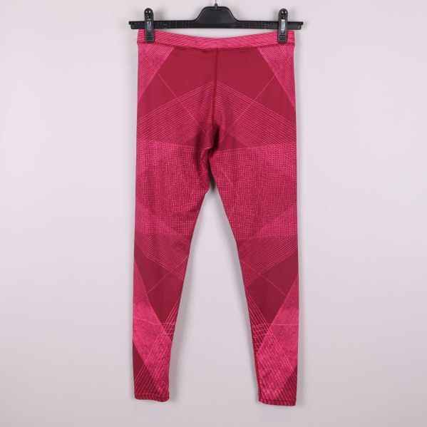 Baksida av rödrosa grafiska Nike tights på galge