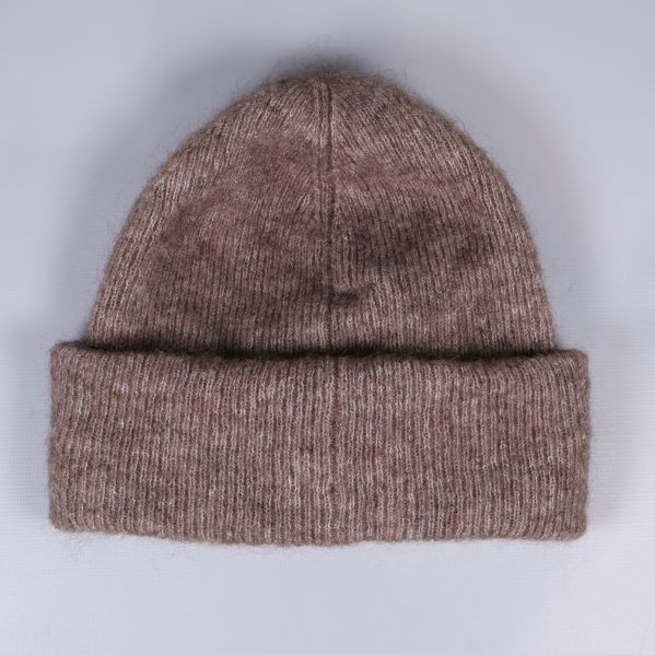 Stickad brun mössa med uppvikt kant sedd bakifrån