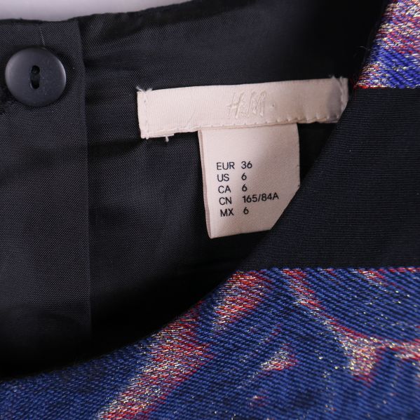 Storleksetikett med H&M och EU storlek 36