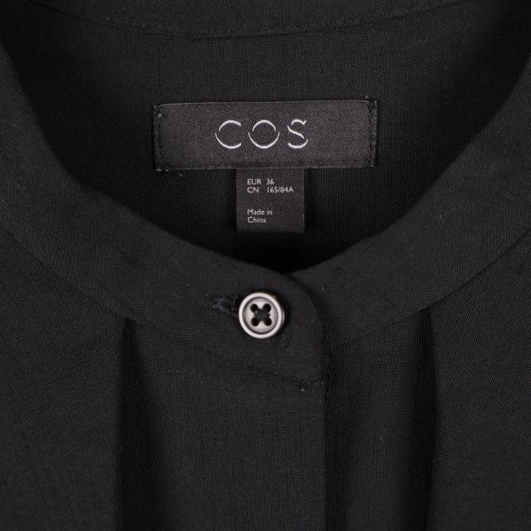Närbild på COS-logotyp i nacke