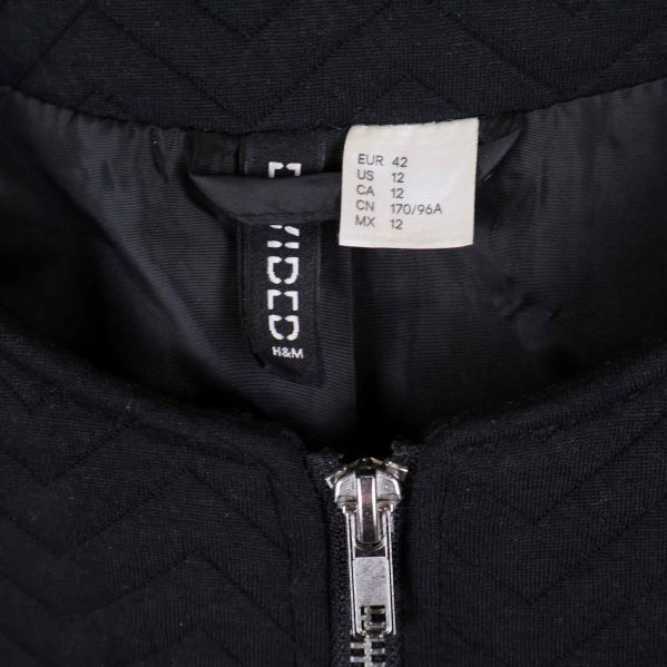 Etikett i nacken för H&M svart jacka, storlek 42