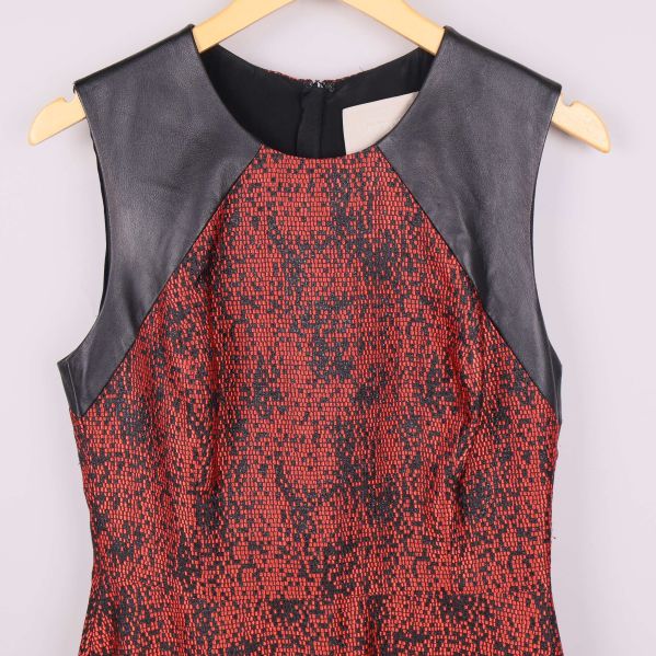 Närbild axelparti i svart skinn på klänning