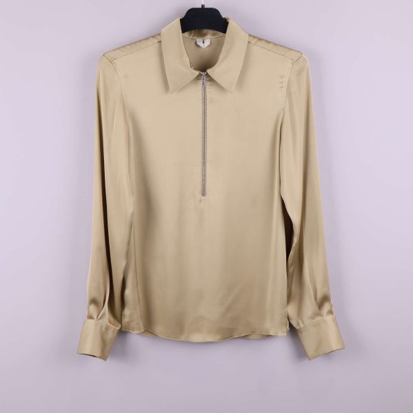 Beige långärmad blus med dragkedja fram på galge