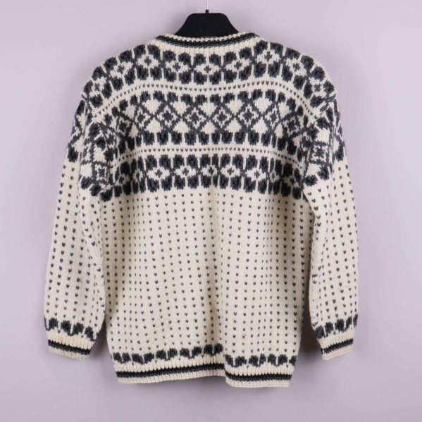 Stickad kofta med mönster visas bakifrån