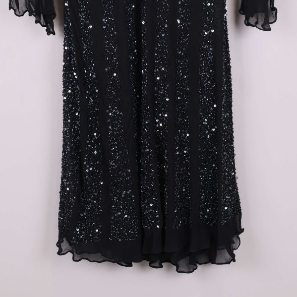 Närbild på klänningens nederdel med glittrande paljetter