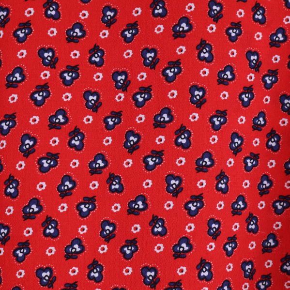 Närmast synliga blommönster på röd tyg