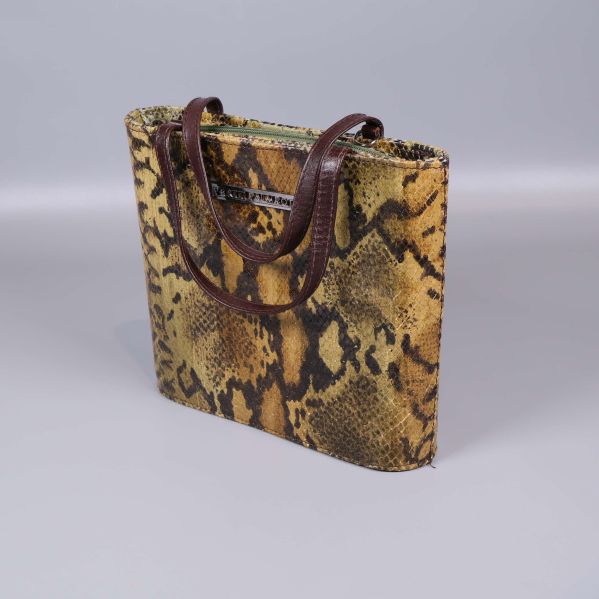 Ormmönstrad väska med bruna handtag i profil
