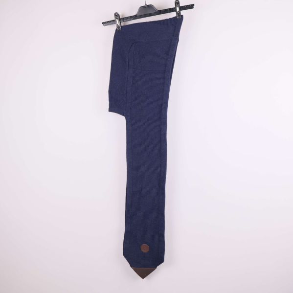 Lång mörkblå stickad halsduk med huva upphängd på galge