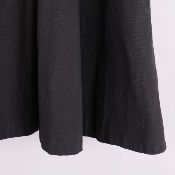 Närbild på tyget i kjolens nederdel, svart och lätt struktur