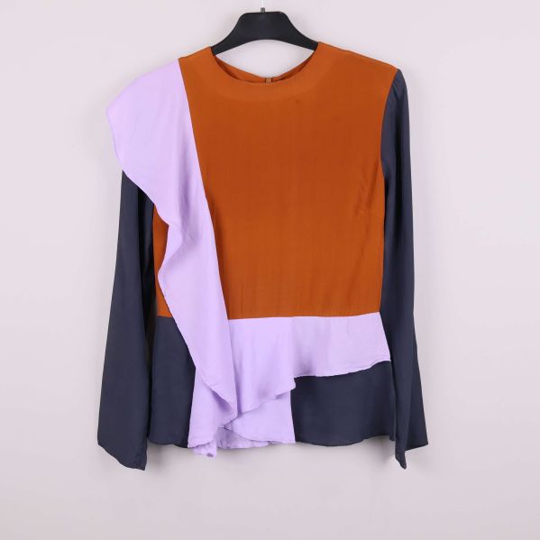 Blus i lila brunt och mörkblått med asymmetrisk volang framtill