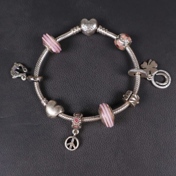Armband sett uppifrån med synliga hjärt- och fredsberlocker