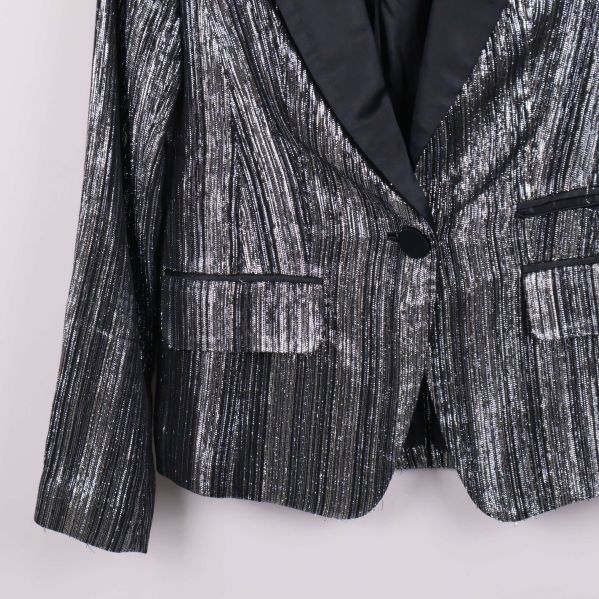 Närbild på kavajens glittrande tyg och strukturer