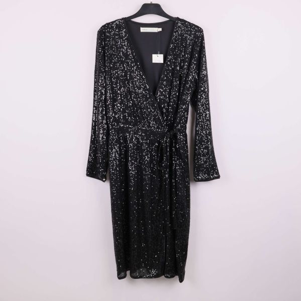 Svart omlottklänning med paljetter hänger på galge