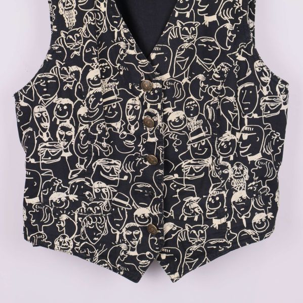 Närbild på nedre delen av väst,  knappar med logo