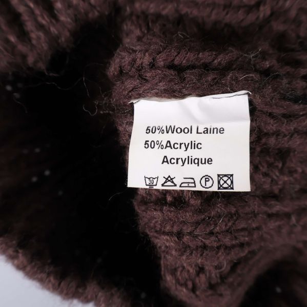 Materiallapp visar innehåll 50% ull och 50% akryl