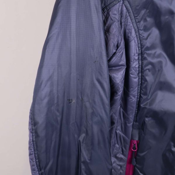 Närbild på mörkblå ärm med små märken