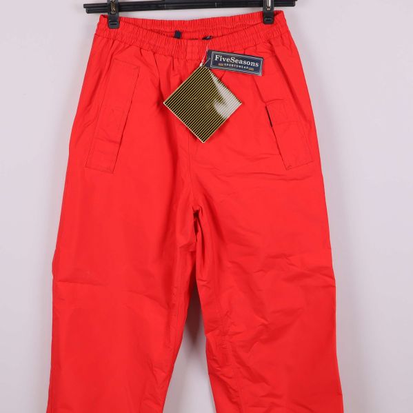 Närbild på röda byxor med fickor och etiketter