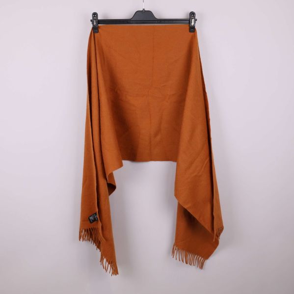 Orange halsduk med fransar upphängd och utvikt