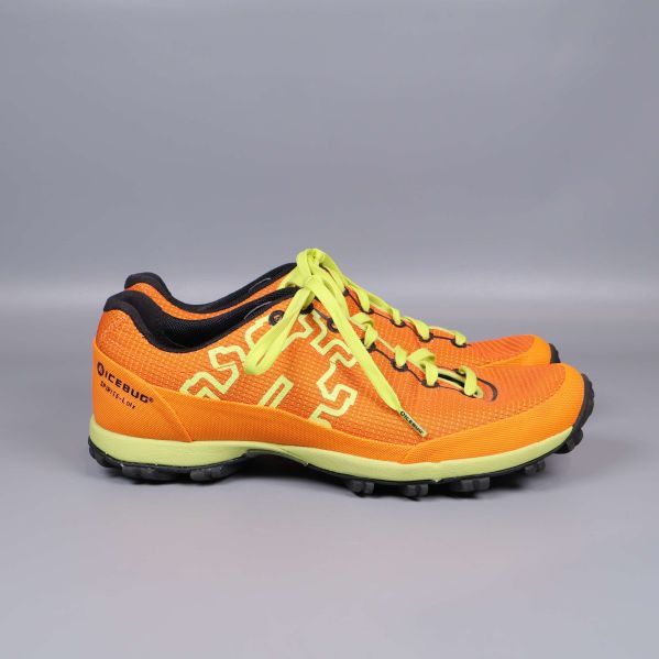 Sido­bild av orange terrängsko med gult mönster och sula