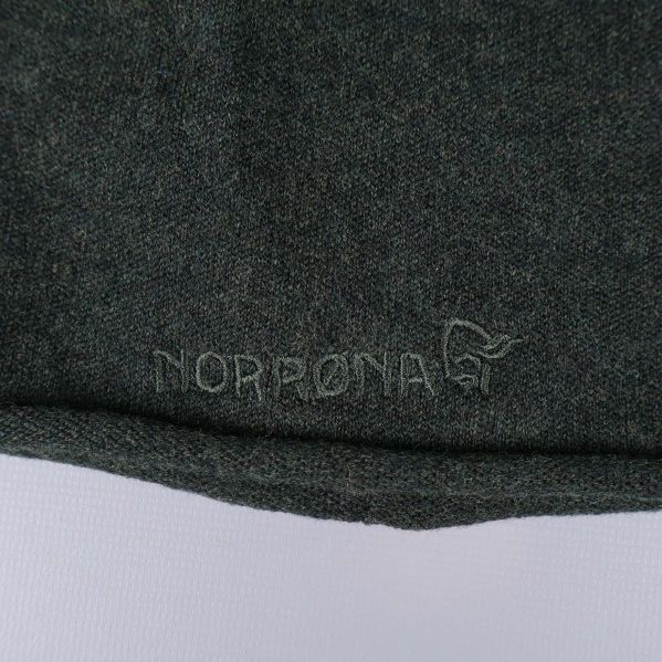 Närbild på broderad Norrona-logga på mössa