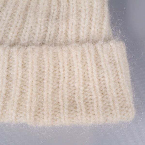 Närbild på ribbstickad kant i krämvit färg