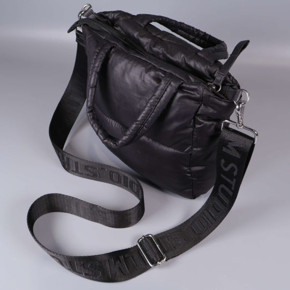 Närbild på axelremmen med tryckt logotyp och metallspänne