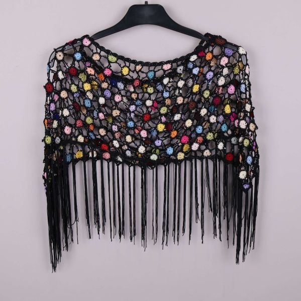 Framsida av virkad poncho med fransar och blommigt mönster